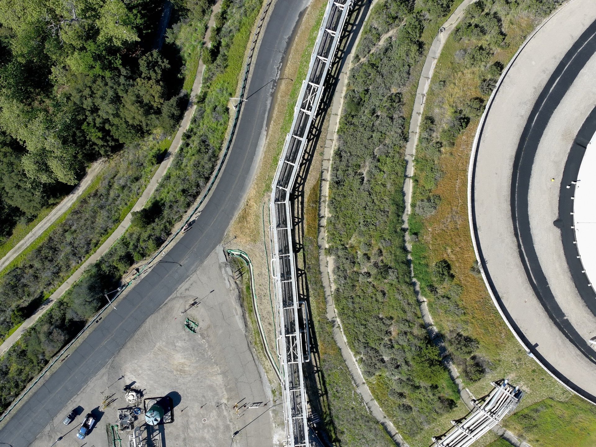 Aerial view of pipeline corridor and circular storage tank