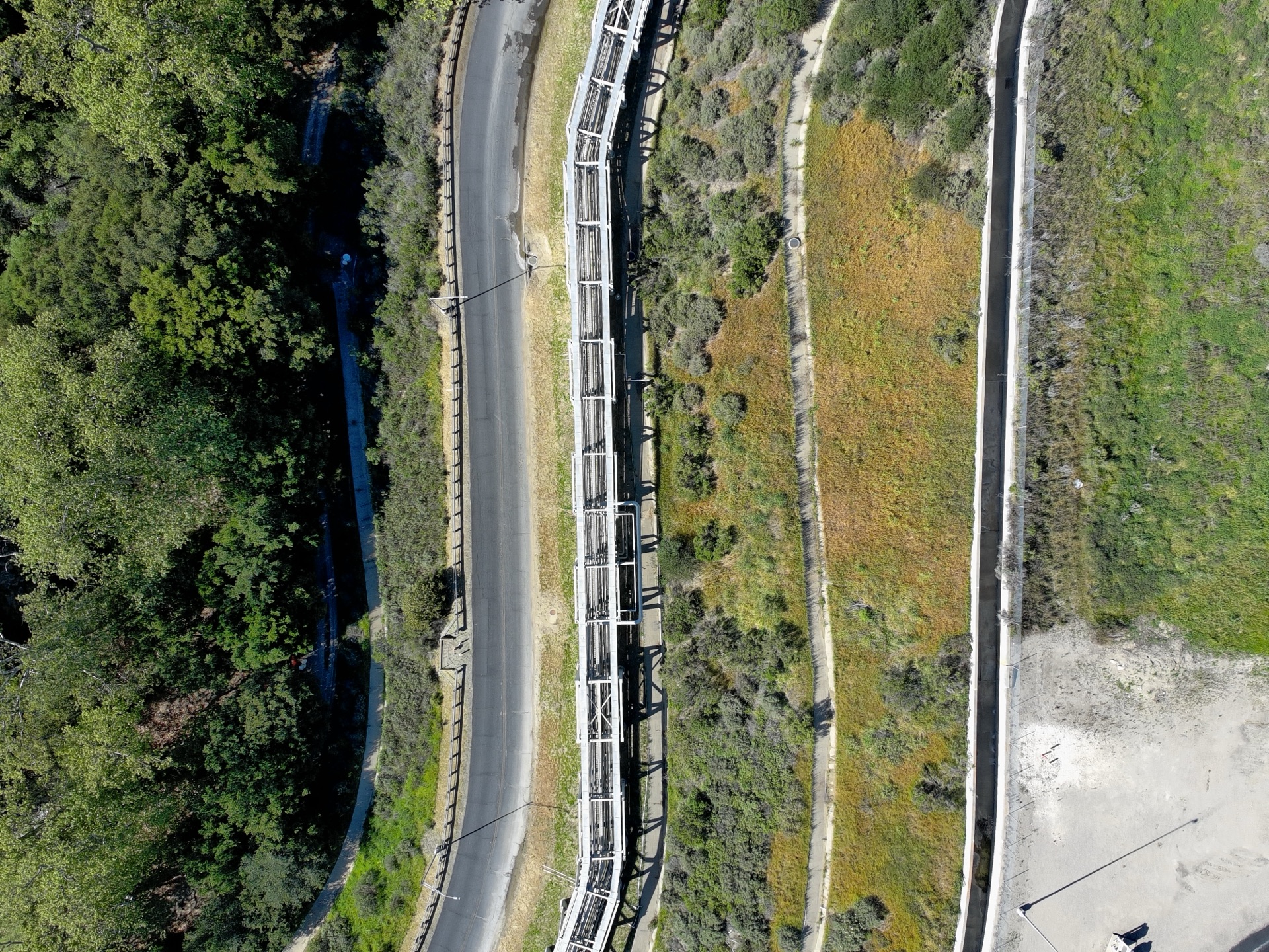 Pipeline running through green hillside terrain