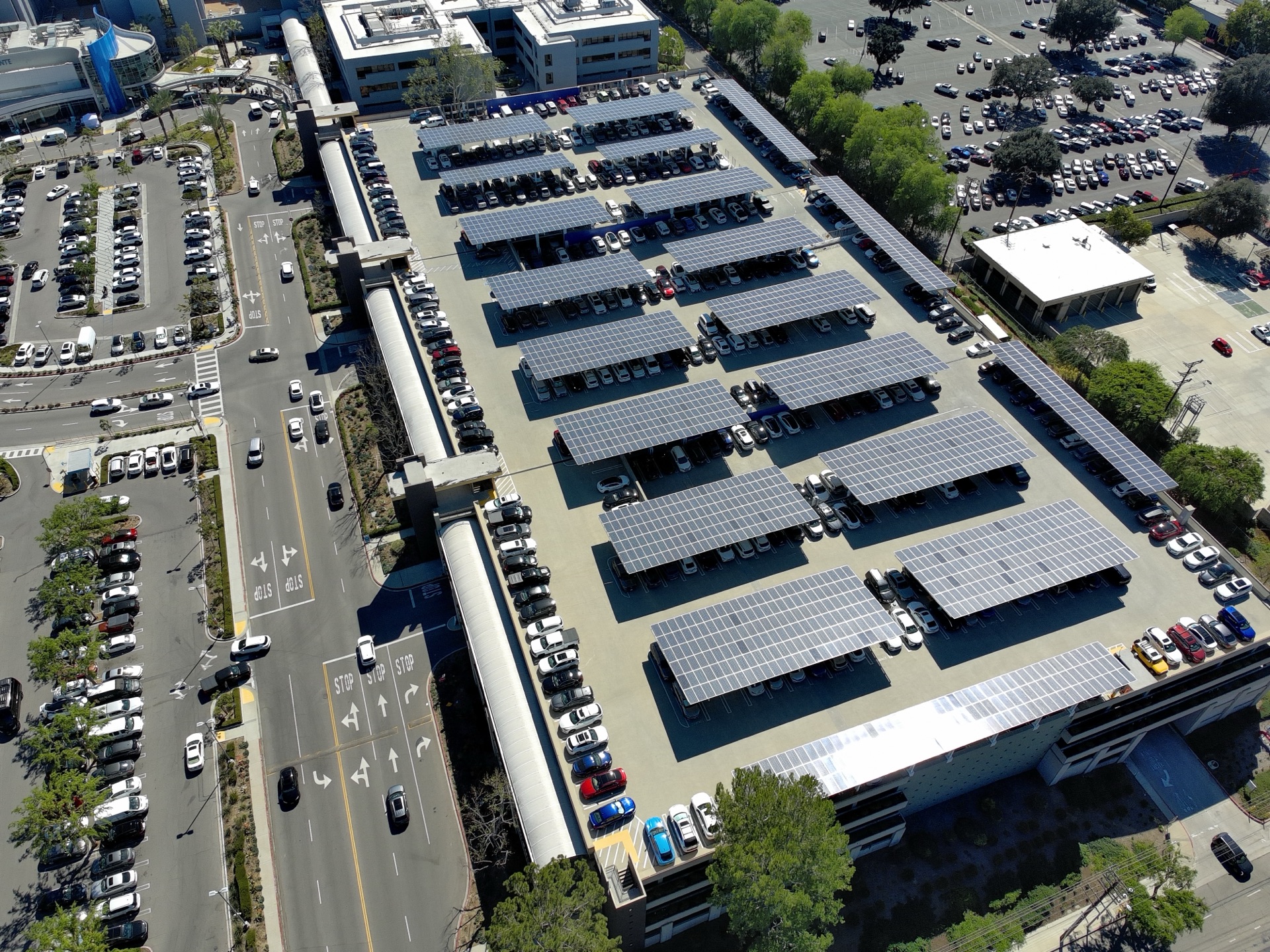 Aerial view of Kaiser Permanente solar carport array covering parking structure