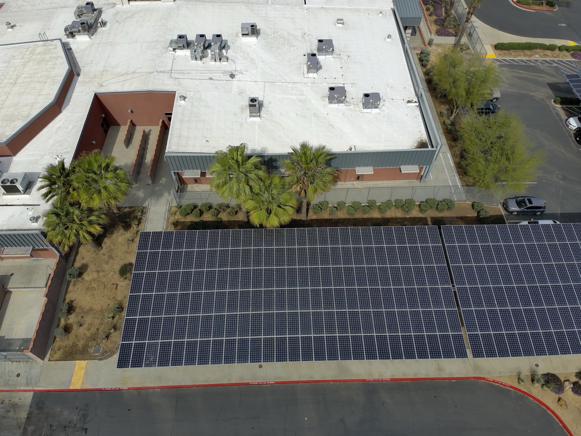 Solar carport adjacent to building